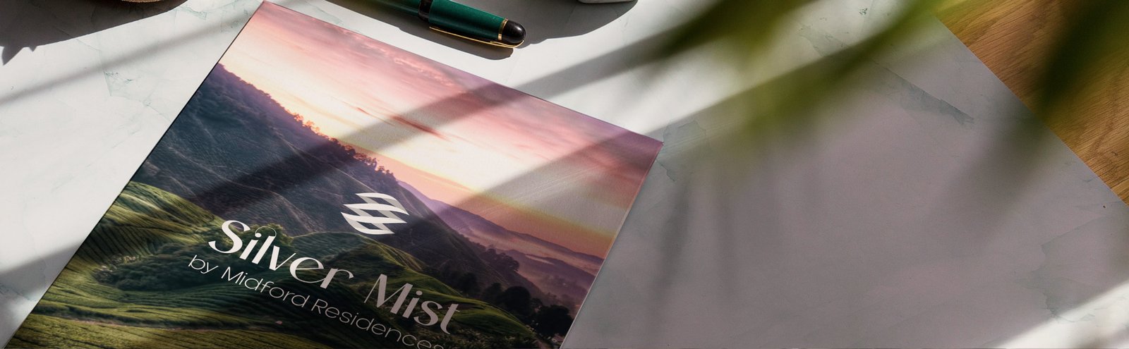 Surreal, the Silver Mist brochure for Midford Residences resting on a desk