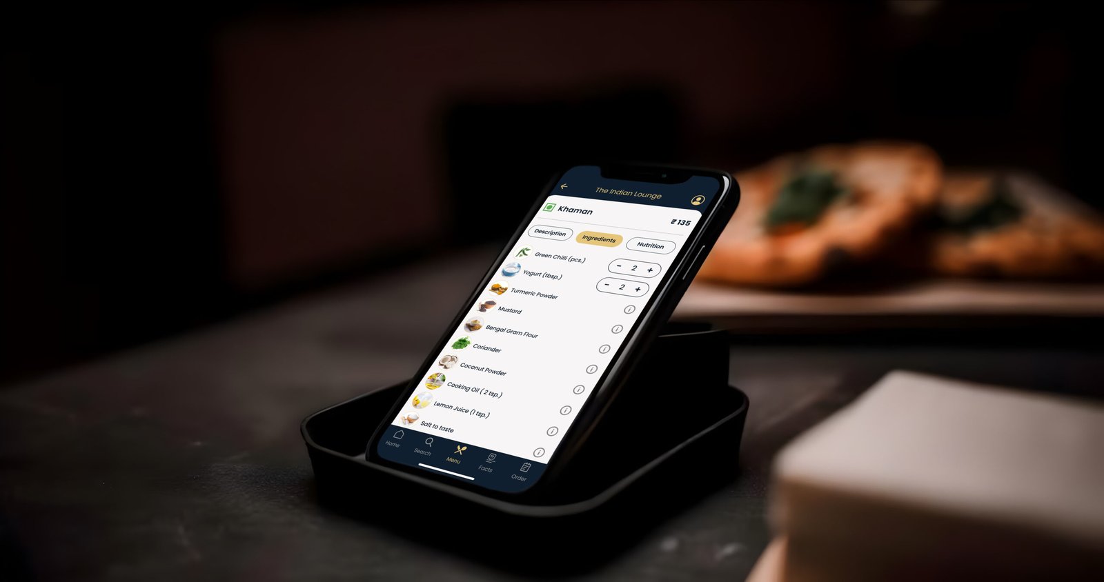 Aroma showing a dish broken down by ingredients on a phone propped on a stand